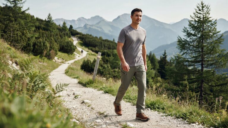 Man hiking on a mountain trail wearing the Best Breathable Outdoor Pants for Men, featuring lightweight fabric, moisture-wicking comfort, and flexible performance for outdoor adventures and trekking